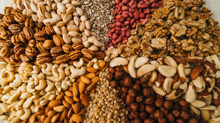 Nuts mix in a canvas bag in table. Ten kinds of nuts: pecan, brazil, cedar, sunflower, hazelnut, almond, peanut walnut pistachio cashew