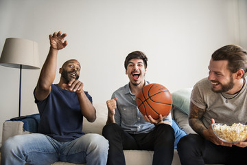 Friends cheering sport league together