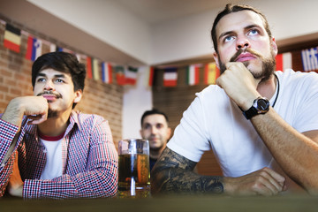 Frieds cheering sport at bar together