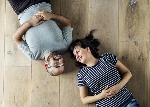 Family Lying On Wooden Floor