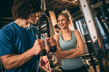 Beautiful fitness couple having fun in the gym.