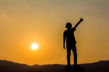 Silhouette small girl playing at sunset background