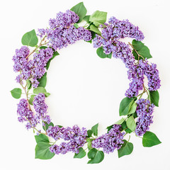 Floral frame composition with lilac flowers branches on white background. Flat lay, top view. Flower pattern