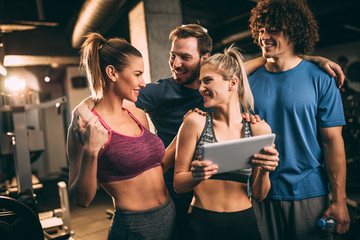 Happy friends having fun in fitness center.
