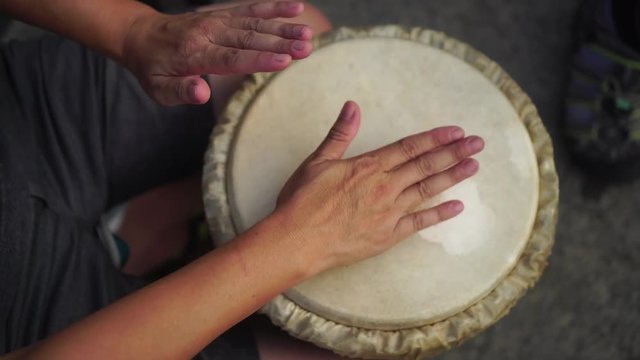 playing music with Brazil drum, hand playing shot