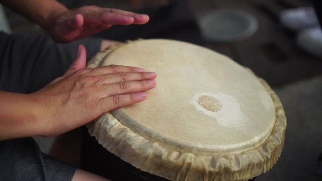 playing music with Brazil drum, hand playing shot