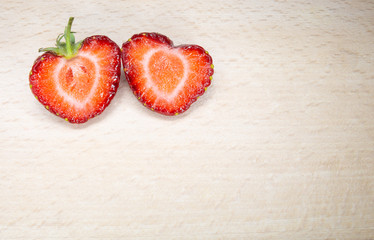 A half-cut strawberry almost seems to form a heart. A typical summer fruit that is the season of love.A good and healthy type of fruit that contains few sugars.