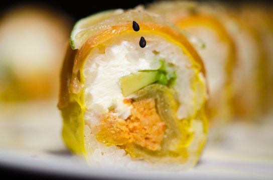 Sushi rolls in white plate and dark background