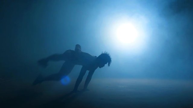 Asian sportsmen is falling down on the ground while doing stunt.