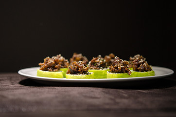 Sushi rolls in white plate and dark background
