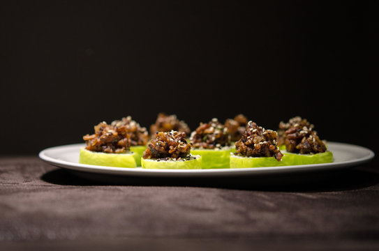 Sushi rolls in white plate and dark background