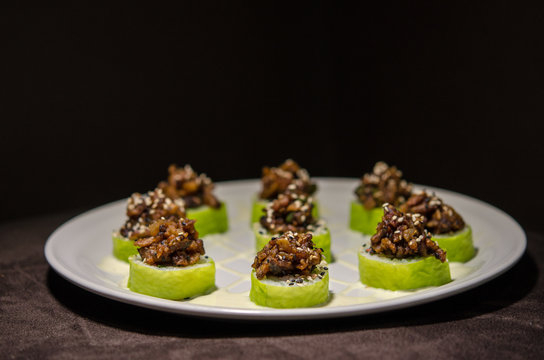 Sushi rolls in white plate and dark background