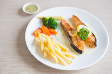 Salmon slice steak with yellow lemon decorated and vegetable, Fish &  chip