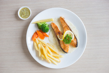 Salmon slice steak with yellow lemon decorated and vegetable, Fish &  chip