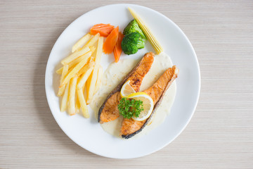 Salmon slice steak with yellow lemon decorated and vegetable, Fish &  chip