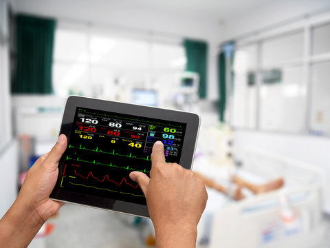 Doctor Online Checking Patient Monitor By Use Tablet And Wifi Technology In Intensive Care Unit (ICU), Tablet Telehealth Concept, Remote Medical Doctor Monitoring