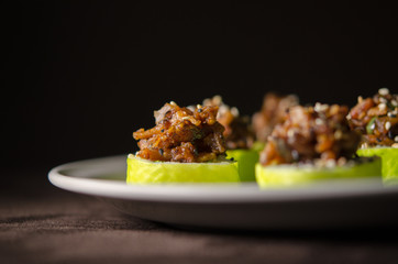Sushi rolls in white plate and dark background