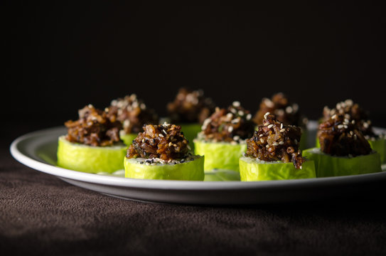 Sushi rolls in white plate and dark background