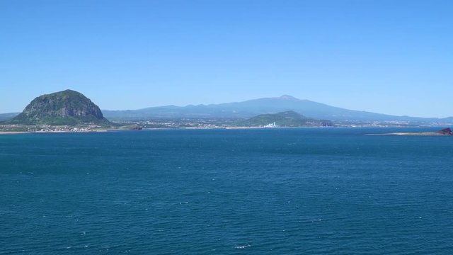 Landscape of southwestern coast of Jeju Island with Sanbangsan and Hallasan mountain, viewed from Olle trail No.10 at Songaksan mountain.