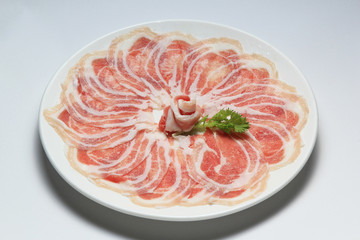 Slice pork in white plate for shabu