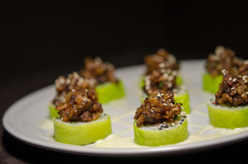 Sushi rolls in white plate and dark background