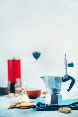 Brewing coffee in Moka pot. Morning coffee with cookies concept with copy space