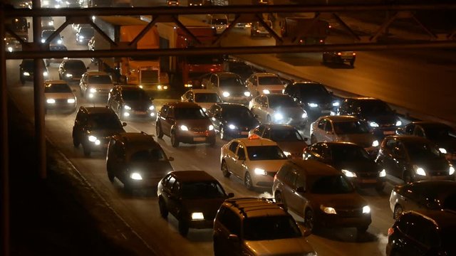 Car traffic jam on the highway. Evening, night, headlight 