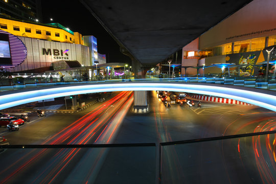 Bangkok,Thailand - 31 October 2017 : Night light with long speed shutter of traffic at MBK, BTS Siam interchange in front of Siam Discovery and Art Museum junction on Halloween night