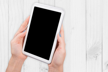 Woman hand using mock up digital tablet clipping patch on wood white light background