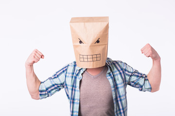 Man with cardboard box on his head and drawing of angry emoticon face. Angry man starting a fight.