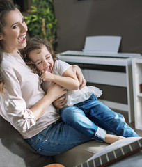 Obraz premium Happy mother with a daughter at home