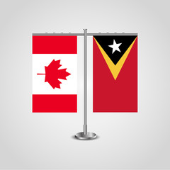 Table stand with flags of Canada and East Timor.Two flag. Flag pole. Symbolizing the cooperation between the two countries. Table flags