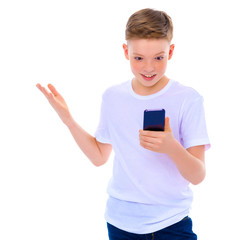 Fototapeta premium A little boy uses a mobile phone.