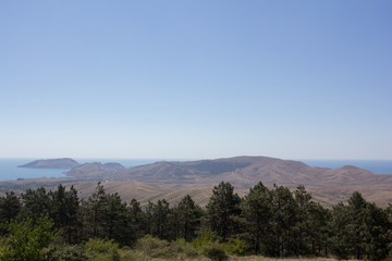 A view of the mountains and the sea on a summer day.