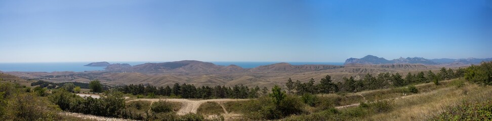 Panoramic view of the mountains and the sea in the summer.