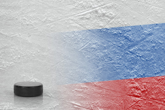 Hockey puck and Russian flag on ice