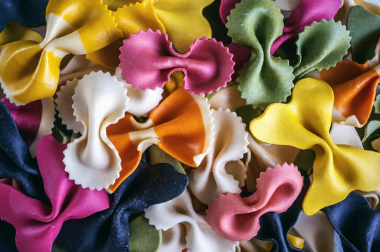 Mixed selection of dried pasta on wooden background. Background.