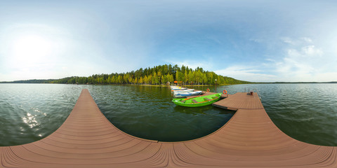 Pier on the lake with boats near the forest. Full spherical 360 by 180 degrees seamless panorama