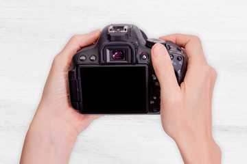 DSLR camera in hand isolated