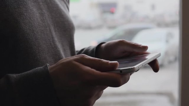 Digital tablet computer in male hands, touching and scrolling. Closeup shot.