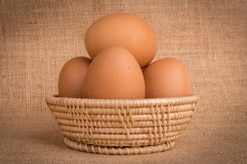 Eggs in a basket on  gunny (sackcloth)  background