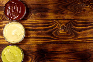 Set of sauces on wooden table