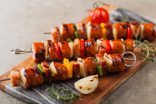 Grilled Skewers With Sausage, Bacon And Vegetables.