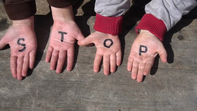 children hands with the word stop
