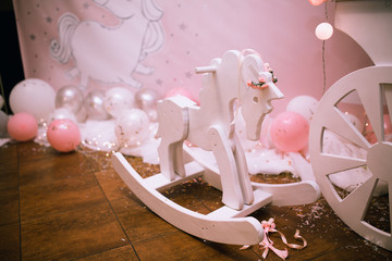 wooden white swing in the form of a unicorn for a children's holiday