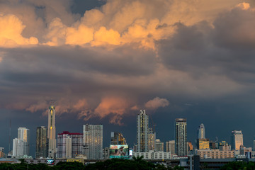 storm clouds above bangkok city with beautiful sunset light