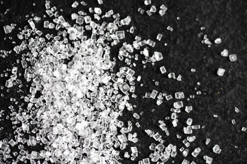 sugar on black background macro close up