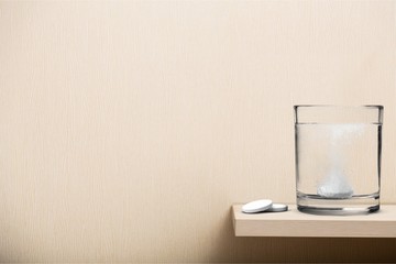 Glass of water and pill