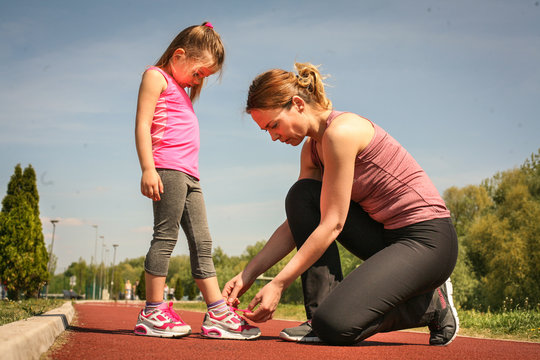 Mother and daughter prepare for sport activity. - Powered by Adobe