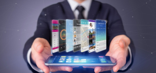 Businessman holding 3d rendering app template on a smartphone